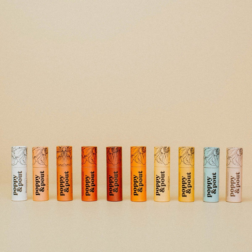 10 poppy and pout lip balms lined up in a row